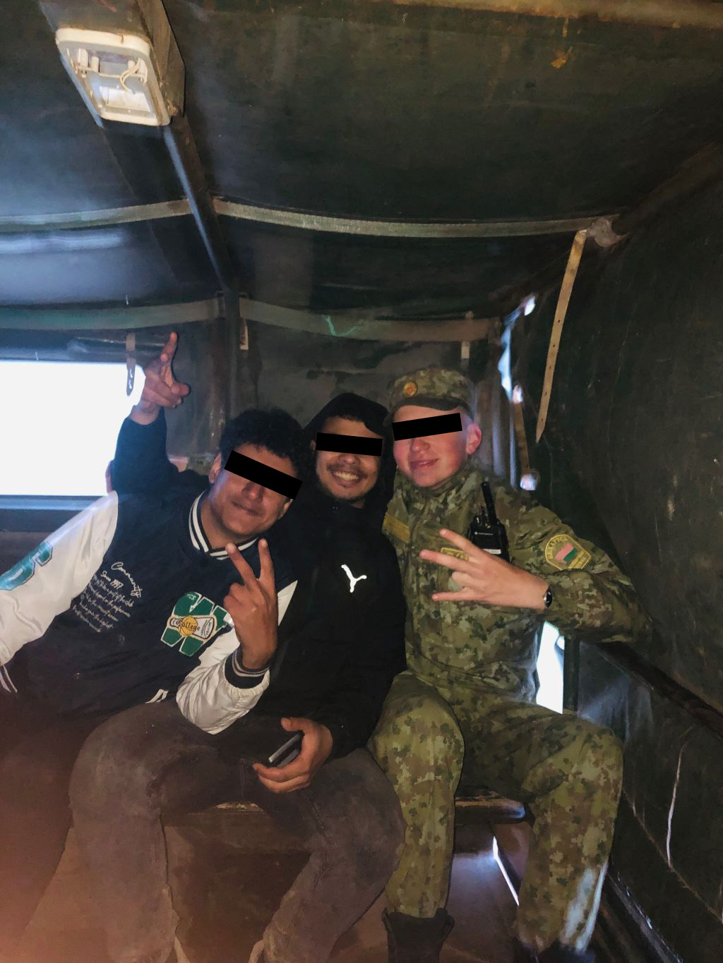 Belarusian border guard escorting illegal migrants